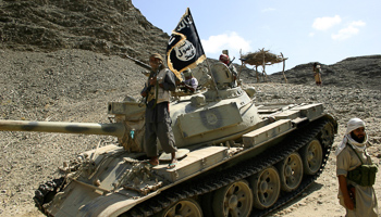 Members of Al-Qaida’s Ansar al-Sharia guard a road leading to the town of Jaar (Reuters/Stringer)
