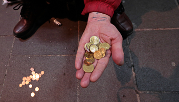 A homeless man displays coins as he begs in Nice, France (Reuters/Eric Gaillard)