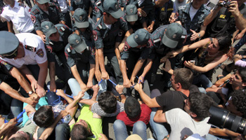 Protesters against a hike in electricity prices scuffle with policemen in Yerevan, Armenia (Reuters/Hayk Baghdasaryan/Photolure)
