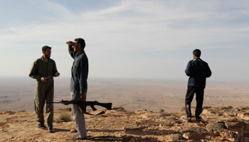 Rebel fighters patrol in the desert south of the Libyan town of Ar Rujban (Reuters/Youssef Boudlal)