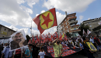 People march with flags and banners of the pictures of victims who were killed in a bomb attack in Suruc, during a funeral ceremony in Istanbul (Reuters/Murad Sezer)