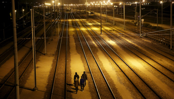 Migrants walk after crossing a fence as they attempt to access the Channel Tunnel, France (Reuters/Juan Medina)