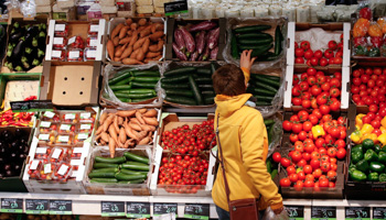 A woman checks vegetables at the Biocompany organic supermarket in Berlin (Reuters/Fabrizio Bensch)