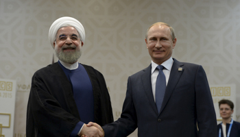 Vladimir Putin shakes hands with Hassan Rouhani (Reuters/RIA Novosti)
