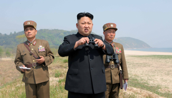 Kim Jong Un guides a multiple-rocket launching drill (Reuters/KCNA)