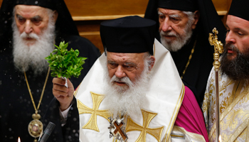 Leader of Greek Orthodox Church Archbishop Ieronimos blesses deputies elected to parliament, Athens (Reuters/Yannis Behrakis)