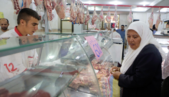 A woman buys meat in downtown Algiers (Reuters/Louafi Larbi)