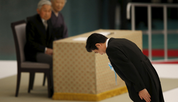 Shinzo Abe bows during a ceremony marking the 70th anniversary of Japan's surrender in World War Two, at Budokan Hall in Tokyo