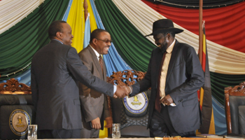Kiir is congratulated after signing the peace agreement, Juba (Reuters/Jok Solomun)