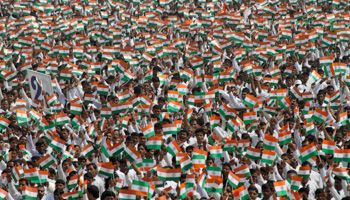 People waving miniature national flags in Lucknow (Reuters/Pawan Kumar)