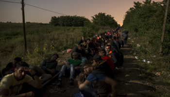 Migrants, hoping to cross into Hungary, sit along a railway track outside the village of Horgos in Serbia (Reuters/Marko Djurica)