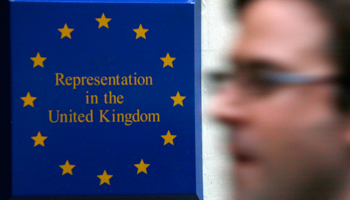 A man passes a sign outside the European Commission offices in London (Reuters/Luke MacGregor)