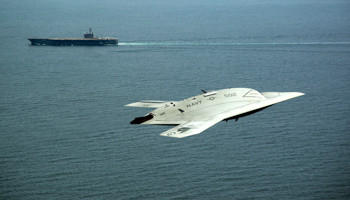 An X-47B drone near aircraft carrier USS George H.W. Bush (Erik Hildebrandt/U.S. Navy/Reuters)