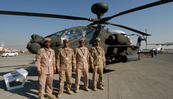 UAE army pilots pose in front of the AH-64D Apache helicopter (Reuters/Nikhil Monteiro)