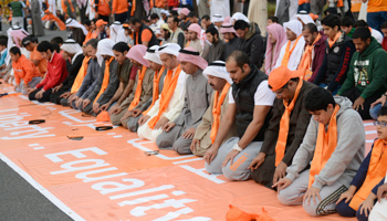 People pray before a march at the Gulf Road in Kuwait (Reuters/Stephanie McGehee)