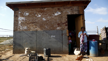 A woman knits in front of her house in San Quintin in Baja California state, Mexico (Reuters/Edgard Garrido)