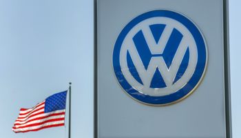 An American flag flies next to a Volkswagen car dealership in San Diego, California (Reuters/Mike Blake)