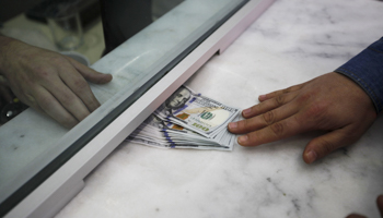 A man changes money at a currency exchange office in Istanbul (Reuters/Osman Orsal)