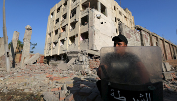 A security official guards the site of a bomb blast at a state security building in Shubra Al-Khaima, on the outskirts of Cairo, (Reuters/Mohamed Abd El Ghany)