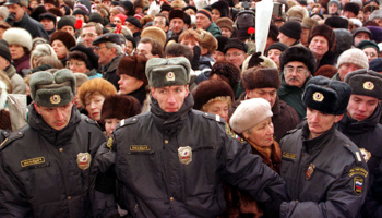 Police officers stand in line as they protect a procession  (Reuters)