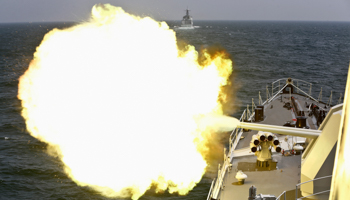 A Chinese navy vessel fires its cannon during the Joint Sea-2014 naval drill outside Shanghai (Reuters/China Daily)