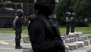 Police stand guard next to seized packages of cocaine during a drug presentation in Panama City (Reuters/Carlos Jasso)