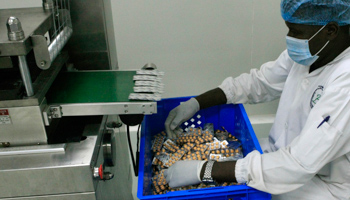 An employee inspects medication tablets produced at Azal Pharmaceutical Industries in Khartoum, Sudan (Reuters/Mohamed Nureldin Abdallah)