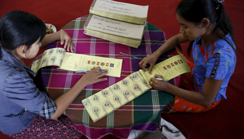 Women label ballots at a polling station ahead of the general election in Mandalay, Myanmar, November 7, 2015 (Reuters/Olivia Harris)