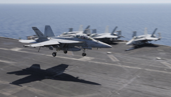 A F/A-18E/F Super Hornets of Strike Fighter Attack Squadron 211 (VFA-211) lands on the flight deck of the USS Theodore Roosevelt (CVN-71) aircraft carrier in the Gulf June 18, 2015 (Reuters/Hamad I Mohammed)
