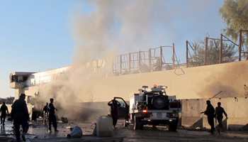 Afghan firefighters and security forces try to douse a fire after a suicide car bomb blast attacked a military convoy in Lashkar Gah, Helmand province, Afghanistan  (Reuters/Abdul Malik)