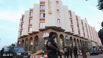 A Malian police officer stands guard in front of the Radisson hotel in Bamako, Mali (Reuters/Joe Penney)