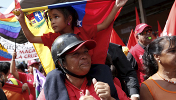 A government supporter and her daughter at a campaign rally (Reuters/Carlos Garcia Rawlins)