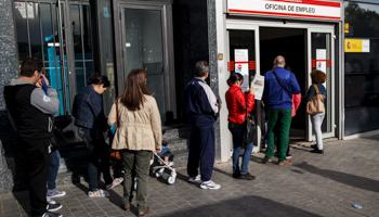 People stand in a line to enter a government employment office in Madrid, Spain (Reuters/Andrea Comas)