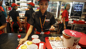 Staff sell meals at a KFC branch on its opening day in Yangon, Myanmar (Reuters/Soe Zeya Tun)