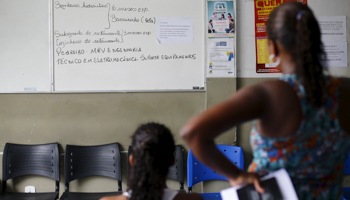 Unemployed women look at jobs opportunities at a job agency in Itaborai, Brazil (Reuters/Ricardo Moraes)