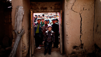 Villagers outside a house in Yuangudui, Gansu Province  (Reuters/Carlos Barria)