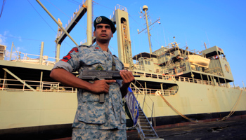 An Iranian soldier guard Iranian Navy helicopter carrier Kharg at Port Sudan (Reuters/Mohamed Nureldin Abdallah)