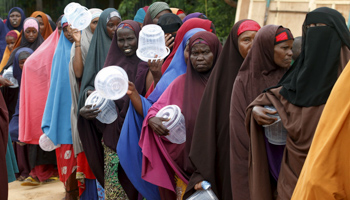 Somali families wait in a queue to receive food from a charity (Reuters/Feisal Omar)