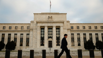 A man walks past the main Federal Reserve building in Washington DC (Reuters/Kevin Lamarque)