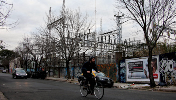 A cyclist in front of Edenor electric company power distribution plant in Buenos Aires (Reuters/Marcos Brindicci)