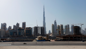 Construction cranes are seen near Burj Khalifa in Dubai (Reuters/Jumana El Heloueh)