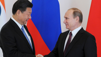 Russian President Vladimir Putin shakes hands with Chinese President Xi Jinping (Reuters/Mikhail Klimentyev)