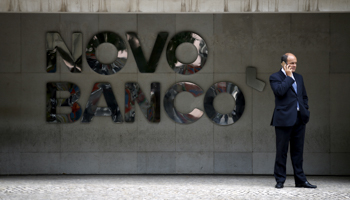 A man uses a mobile phone outside Novo Banco's headquarters in Lisbon, Portugal (Reuters/Rafael Marchante)