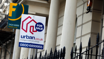 Estate agent signs are displayed outside residential properties in London (Reuters/Neil Hall)
