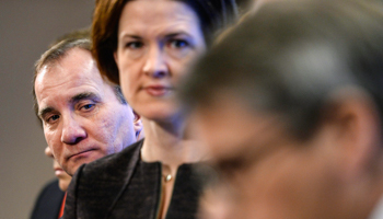 Prime Minister Stefan Lofven, left, looks over the shoulder of Moderate Party leader-elect Anna Kinberg Batra  (Reuters/Maja Suslin/TT News Agency)