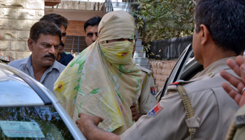 Police escort a suspected militant (face covered) in Rajasthan (Reuters/Stringer)