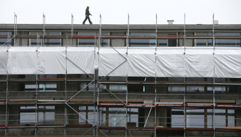 A worker walks on scaffoldings in Berlin, Germany (Reuters/Fabrizio Bensch)