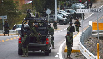 Soldiers of the Mexican Army stand guard at the entry of Petaquillas village, Guerrero (Reuters/Emiliano Torres)