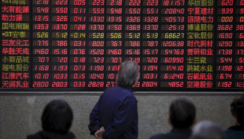 Investors look at an electronic board showing stock information at a brokerage house in Shanghai, China (Reuters/Aly Song)