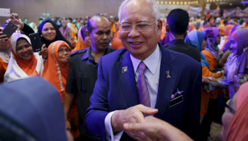 Malaysia's Prime Minister Najib Razak shakes hands with supporters at a Felda Club event in Kuala Lumpur (Reuters/Olivia Harris)